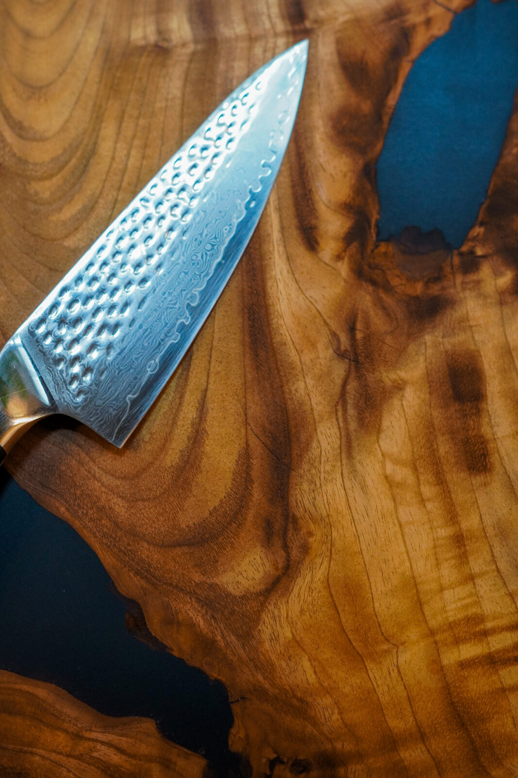 Close-up of live-edge board handle and knife detail